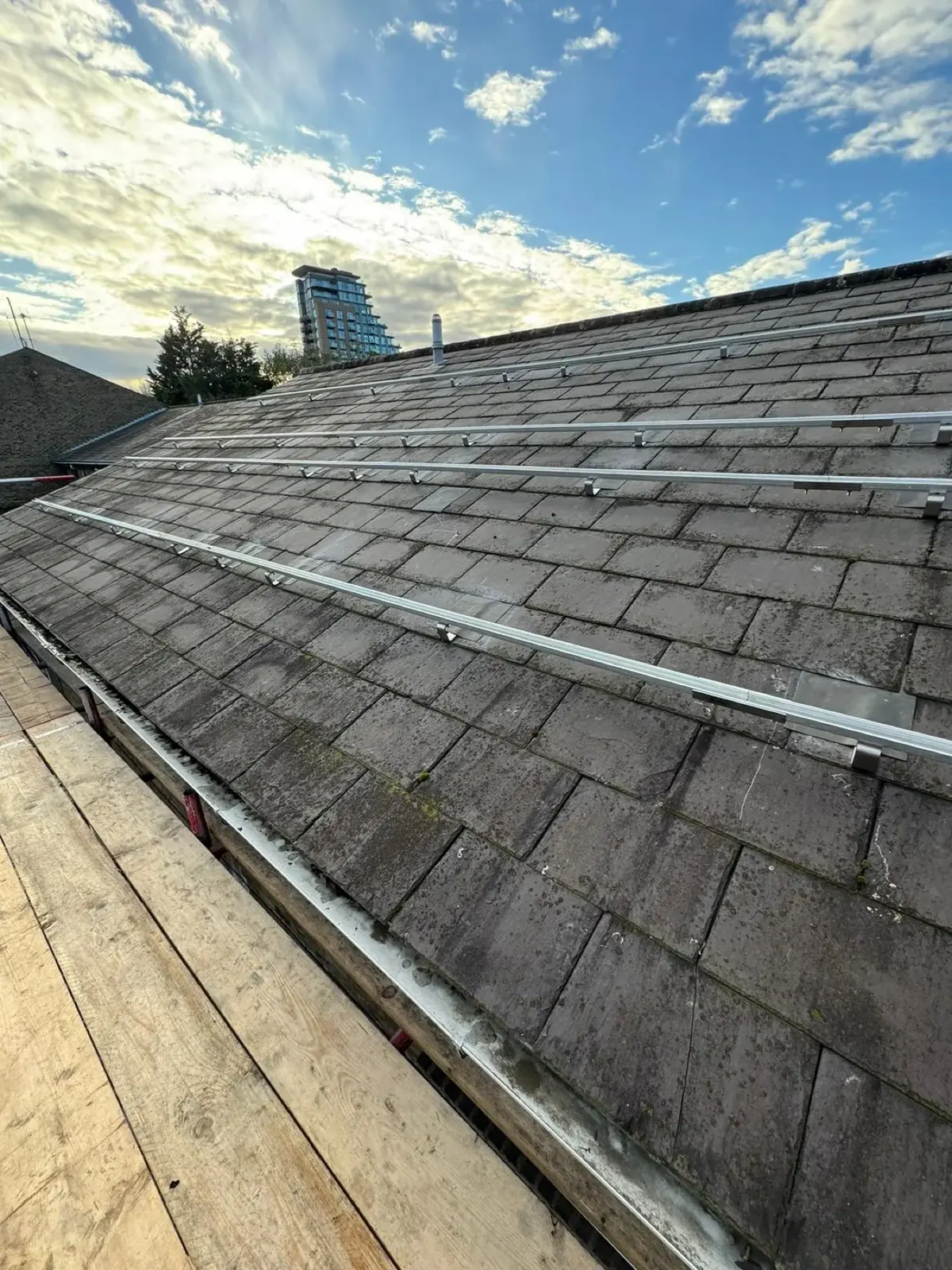 A London rooftop mid-installation with the city behind